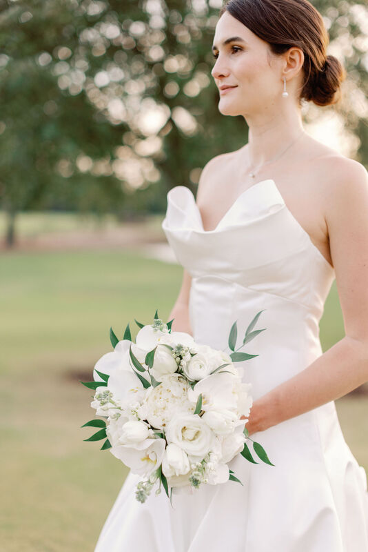 Bride, White Strapless Wedding Dress, White Rose Bridal Bouquet with Pops of Greenery, Wedding Florals, Golf Course Background, Sunset Photos, Bridal Portrait, Looking Off in the Distance, Wedding day Photography, Cape Fear Country Club, Knot Too Shabby Events, Wilmington Wedding Planner, NC Wedding Planner, 