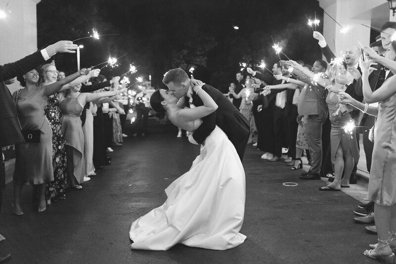 Bride and Groom Sparkler Send Off, Black and White Photo, End of Wedding Day, Wedding Night, Sparkler Aisle, Dip and Kiss, White Strapless Wedding Dress, Black Tux, Black Bow Tie, Black Suspenders, White Undershirt, Happy Couple, Husband and Wife, Wedding Day Photography, Cape Fear Country Club, Knot Too Shabby Events, Wilmington Wedding Planner, NC Wedding Planner, 
