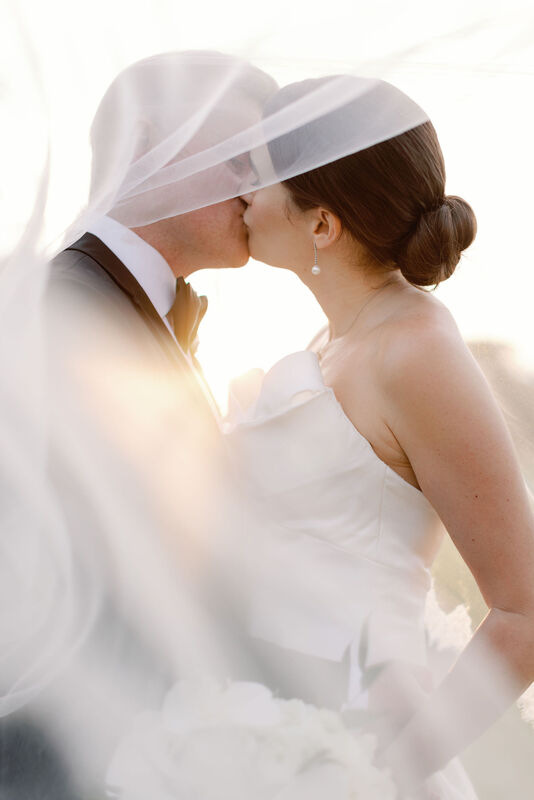 Bride and Groom, Close Up Kiss Under Veil, Sunset Photos, Sunset Background, Golf Course Landscape, White Strapless Wedding Dress, Black Tux, Black Bow Tie, White Undershirt, Just Married, Husband and Wife, Wedding Day Photography, Couples Photo, Knot Too Shabby Events, Wilmington Wedding Planner, NC Wedding Planner, Cape Fear Country Club, 
